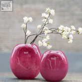 Two glossy magenta ceramic vases from dutz collection with smooth rounded oval shape mouth blown glass look