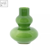 A glossy mouth blown glass vase from dutz collection in jungle green with a double gourd shape and dulz brand name