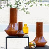 A sleek mouth blown glass vase marco warm orange from the dutz collection with a flared neck and rounded base