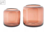 Two amber-toned mouth blown glass vases from the dutz collection with a modern faceted design in burgundy color