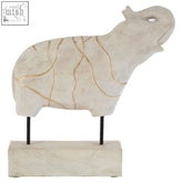 White ceramic sheep figurine with gold crackle glaze detailing next to a vene whitewash mango wood elephant sculpture