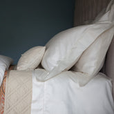 Cream-colored satin pillowcases with subtle embroidery in venice vanilla perfect for luxury fitted sheet sets