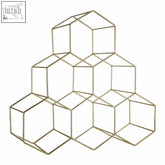 Gold finish wine rack with geometric hexagonal cube design holds six bottles in a stylish bottle gold finish