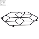 Black metal trivet with geometric diamond pattern and rounded feet from the vertex contour matte black collection