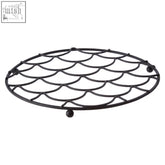 Black metal vertex deco trivet with fish scale pattern and rounded feet for stylish heat protection on countertops