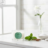 White vetiver and peppermint travel candle in glass jar with coreless clean-burn technology made in england