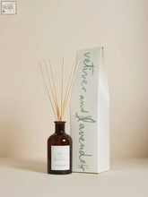 Brown glass vetiver and lavender diffuser with slender wooden sticks and minimalist white label using vegetable oil base