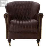 Victor brown leather armchair with diamond-quilted back, vertical stitching, and brass nailhead trim on arms and legs