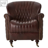 Victor brown leather winged back armchair with diamond-quilted back, curved arms, brass nailhead trim, and casters