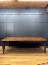 Antique victorian solid walnut extending dining table with rich dark brown finish and ornate turned legs seats 8 to 10