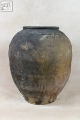 Vintage dark pot ceramic storage jar in dark gray with ribbed lower half and subtle patina finish