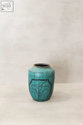 Vintage emerald green pot ceramic jar with black floral design and a slightly chipped rim