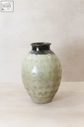 A matte celadon ceramic jar with dark glazed rim and subtle spirals in vintage glazed yunnan style yp09