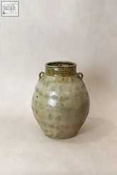 Vintage glazed yunnan pot ceramic jar with rounded body greenish glaze and two small loop handles at the top
