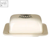 Cream-colored ceramic vintage home cream butter dish with black printed butter label and decorative emblem