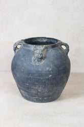 Dark gray weathered ceramic vintage lion ears jar with loop handles and a carved lion ears dark face motif