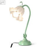 A delicate mint-green vintage nightstand lamp with a lily of the valley acrylic lampshade and slender curved stem
