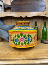 Vibrant handmade metal water pot with colorful floral and sunburst motifs perfect for rustic decor or vase use