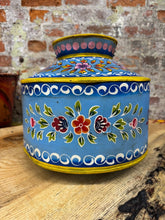 Hand-painted blue ceramic water pot with vibrant floral patterns and yellow trim perfect as a planter or vase