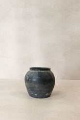 A weathered dark gray ceramic jar with a rounded body and flared rim vintage pot n° 20