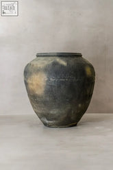 Vintage textured grey ceramic jar with horizontal ribs and aged patina perfect for rustic decor and storage
