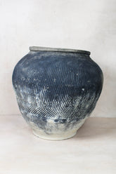 Vintage textured grey ceramic jar with vertical ridges and faded white base perfect for rustic decor