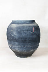 Vintage textured grey ceramic jar with dark blue ribbed texture and rustic worn finish perfect for decor