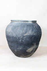 Vintage textured grey handcrafted ceramic jar with fine diagonal ridges and subtle tone variations vintage textured grey
