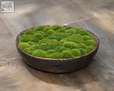 Vintage wooden bowl filled with vibrant green moss balls in a rustic dark wooden design for natural decor