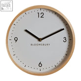 Minimalist vitus small white wall clock with light wood frame black numerals and bloomsbury branding on white wall clock face