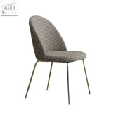 Vivi dining chair with sleek curved back and gray houndstooth fabric on gold metal frame perfect for modern dining