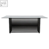 Modern matte black dining table with sleek glass top and horizontal slat black metal design for stylish dining
