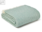 A soft sea green waffle knit wool throw blanket with cream fringe perfect for cozying up size guide inside
