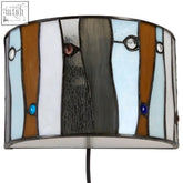 The waldorf jewel deco wall light features a stained glass lampshade with brown, blue, gray stripes and colorful beads