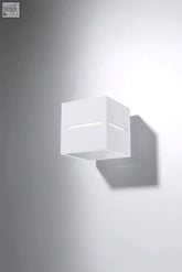 White cube-shaped wall lamp lobo with minimalist design and recessed slits for light bulb diffusion in modern loft style