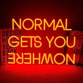 A glowing yellow led neon sign with normal gets you nowhere phrase for wall decor and party use