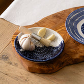 Wave ceramic garlic grater with speckled white and deep blue glaze featuring a textured handcrafted design