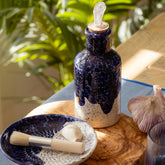 Wave ceramic oil pourer in dark blue and white speckled ceramic with clear glass stopper for easy oil pouring