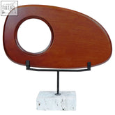 A sleek westo natural wood horizontal sculpture with smooth oval shape and circular cutout on travertine base