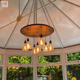 Whiskey barrel pendant light with warm oak wood and exposed filament bulbs perfect for kitchen or client area lighting