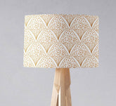 White and gold contemporary table lamp with inch diameter rectangular lampshade on light wood tripod stand