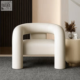 Cream-colored wola chair with plush curves and sleek tubular design in smooth leather upholstery