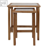 Nestled in a minimalist space, womad large set features two wooden nesting tables with white travertine tops and light brown frames