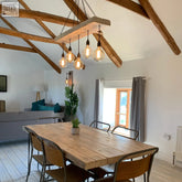 Rustic wooden beam chandelier made of norwegian spruce with exposed edison bulbs hanging by chains for client area lighting and listing photos with lead time info