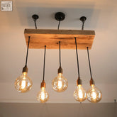 Rustic wooden beam cluster pendant light with five exposed filament bulbs and black cords for kitchen island lighting uk