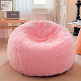 Pink fluffy bean bag cover made of faux fur with a soft plush texture and rounded shape for cozy living room seating