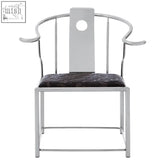 Silver metal yasmin black velvet chair with circular backrest cutout and dark patterned cushion in stainless steel