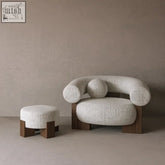 Cream-colored yokina chair with rounded arms and dark solid wood base for stylish comfy seating
