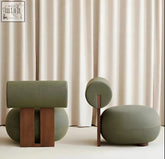 Modern olive-green upholstered yoshiko chair stools with sculptural wooden bases perfect for stylish seating