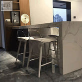 Modern white yves nordic bar stool with sleek metal frame and wooden legs for stylish minimalist seating